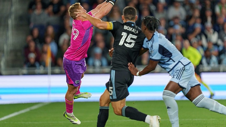 Sep 16, 2023; Saint Paul, Minnesota, USA; Sporting Kansas City goalkeeper Tim Melia (29) punches the ball away on a free kick in the first half with Minnesota United defender Michael Boxall (15) pressing at Allianz Field. Mandatory Credit: Matt Blewett-USA TODAY Sports
