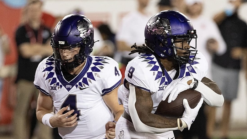 Sep 16, 2023; Houston, Texas, USA; TCU Horned Frogs quarterback Chandler Morris (4) hands the ball off to running back Emani Bailey (9) against the Houston Cougars in the first half at TDECU Stadium. Mandatory Credit: Thomas Shea-USA TODAY Sports