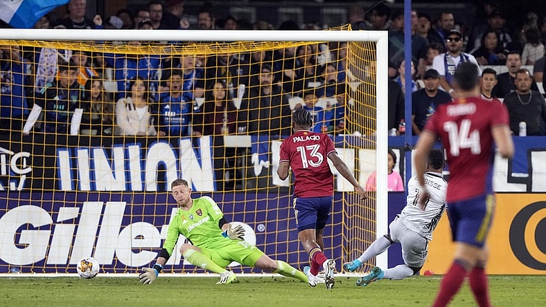 Sep 16, 2023; San Jose, California, USA; Real Salt Lake goalkeeper Zac MacMath (in green) allows a goal by San Jose Earthquakes forward Jeremy Ebobisse (right in gray) during the first half at PayPal Park. Mandatory Credit: Darren Yamashita-USA TODAY Sports