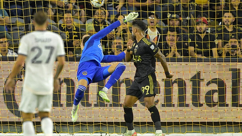 Sep 16, 2023; Los Angeles, California, USA;  Los Angeles FC forward Denis Bouanga (99) scores a goal past Los Angeles Galaxy goalkeeper Jonathan Bond (1) off a pass by Los Angeles Galaxy forward Michael Barrios (12) in the first half at BMO Stadium. Mandatory Credit: Jayne Kamin-Oncea-USA TODAY Sports
