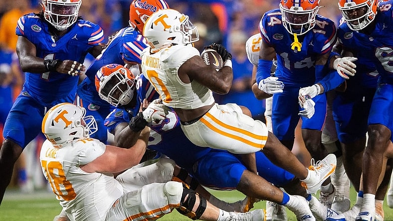 Tennessee running back Jaylen Wright (0) is swarmed by Florida defenders during a football game between Tennessee and Florida at Ben Hill Griffin Stadium in Gainesville, Fla., on Saturday, Sept. 16, 2023.