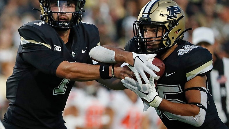 Purdue Boilermakers quarterback Hudson Card (1) hands the ball off to Purdue Boilermakers running back Devin Mockobee (45) during the NCAA football game against the Syracuse Orange, Wednesday, July 12, 2023, at Ross-Ade Stadium in West Lafayette, Ind.