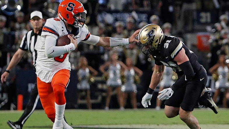 Syracuse Orange quarterback Garrett Shrader (6) stiff arms Purdue Boilermakers defensive back Dillon Thieneman (31) during the NCAA football game, Saturday, Sept. 16, 2023, at Ross-Ade Stadium in West Lafayette, Ind. Syracuse Orange won 35-20.