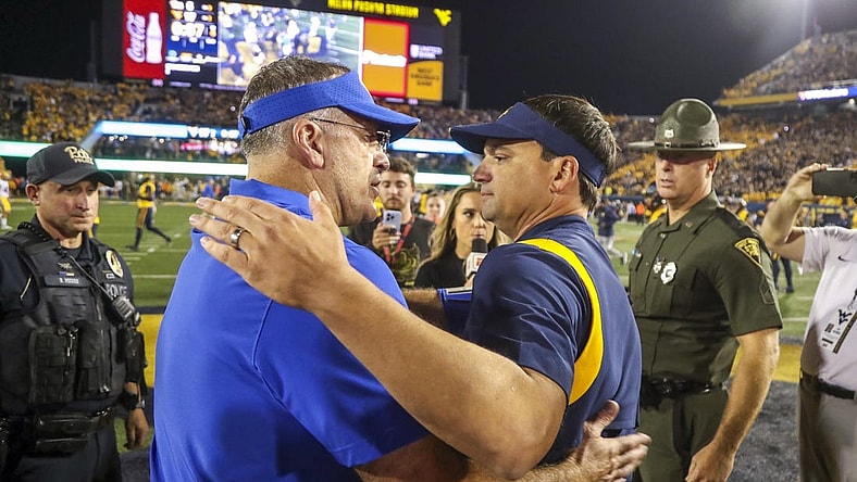 Sep 16, 2023; Morgantown, West Virginia, USA; West Virginia Mountaineers head coach Neal Brown speaks with Pittsburgh Panthers head coach Pat Narduzzi after the game at Mountaineer Field at Milan Puskar Stadium. Mandatory Credit: Ben Queen-USA TODAY Sports