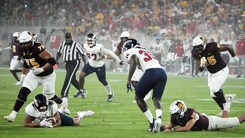 Fresno State Bulldogs defensive lineman Jacob Holmes (23) recovers a fumble by Arizona State Sun Devils quarterback Drew Pyne (10) in the first half at Mountain America Stadium in Tempe on Sept. 16, 2023.