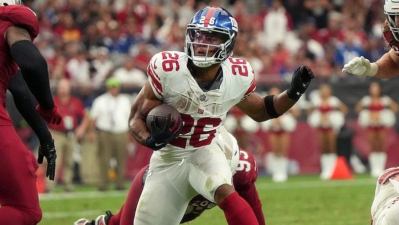 New York Giants running back Saquon Barkley (26) runs the ball against the Arizona Cardinals at State Farm Stadium in Glendale on Sept. 17, 2023.
