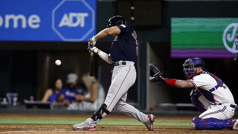 Sep 18, 2023; Arlington, Texas, USA; Boston Red Sox left fielder Rob Refsnyder (30) hits a two run single in the eighth inning against the Texas Rangers at Globe Life Field. Mandatory Credit: Tim Heitman-USA TODAY Sports