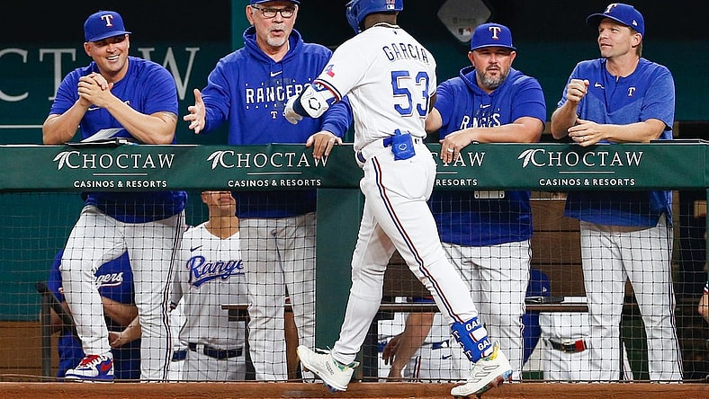 Sep 19, 2023; Arlington, Texas, USA; Texas Rangers manager Bruce Bochy (15) shakes hands with right fielder Adolis Garcia after he hits a home run during the second inning against the Boston Red Sox at Globe Life Field. Mandatory Credit: Andrew Dieb-USA TODAY Sports