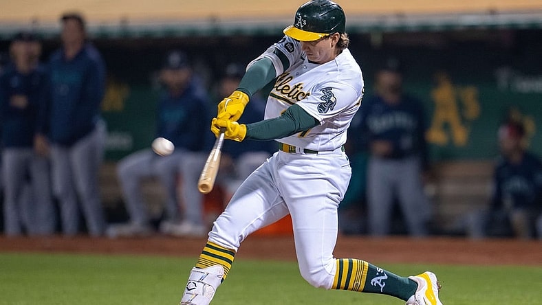 Sep 19, 2023; Oakland, California, USA; Oakland Athletics catcher Shea Langeliers (23) hits a sacrifice fly ball during the seventh inning against the Seattle Mariners at Oakland-Alameda County Coliseum. Mandatory Credit: Neville E. Guard-USA TODAY Sports