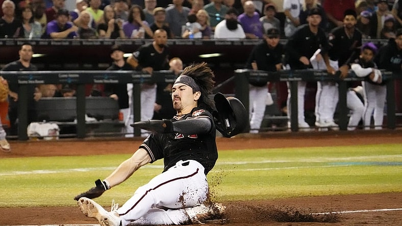 Sep 19, 2023; Phoenix, AZ, USA; Arizona Diamondbacks Corbin Carroll (7) scores on a throwing error by San Francisco Giants catcher Patrick Bailey (14) after stealing third base in the second inning at Chase Field. Mandatory Credit: Rob Schumacher-Arizona Republic