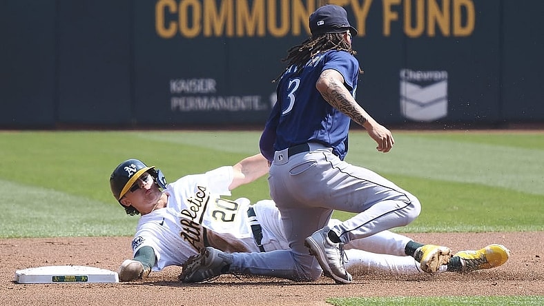 Sep 20, 2023; Oakland, California, USA; Oakland Athletics second baseman Zack Gelof (20) steals second base against Seattle Mariners shortstop J.P. Crawford (3) during the first inning at Oakland-Alameda County Coliseum. Mandatory Credit: Kelley L Cox-USA TODAY Sports