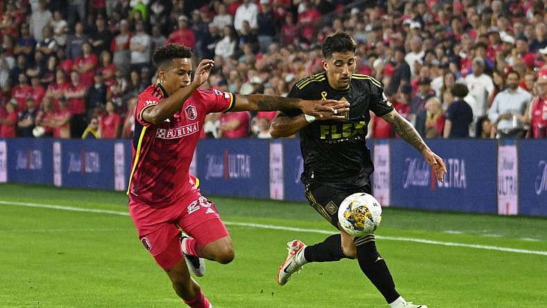 Sep 20, 2023; St. Louis, Missouri, USA; St. Louis City defender Akil Watts (20) and Los Angeles FC midfielder Cristian Olivera (25) chase a loose ball during the first half at CITYPARK. Mandatory Credit: Scott Rovak-USA TODAY Sports
