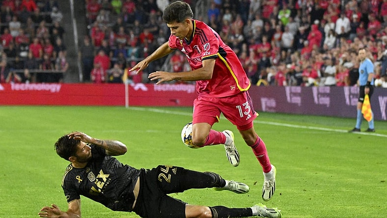 Sep 20, 2023; St. Louis, Missouri, USA; Los Angeles FC midfielder Ryan Hollingshead (24) and St. Louis City defender Anthony Markanich (13) fight for the ball during the second half at CITYPARK. Mandatory Credit: Scott Rovak-USA TODAY Sports