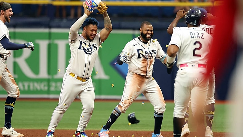Sep 21, 2023; St. Petersburg, Florida, USA; Tampa Bay Rays center fielder Manuel Margot (13) is congratulated after he hit the game winning walk off RBI during the ninth inning against the Los Angeles Angels at Tropicana Field. Mandatory Credit: Kim Klement Neitzel-USA TODAY Sports