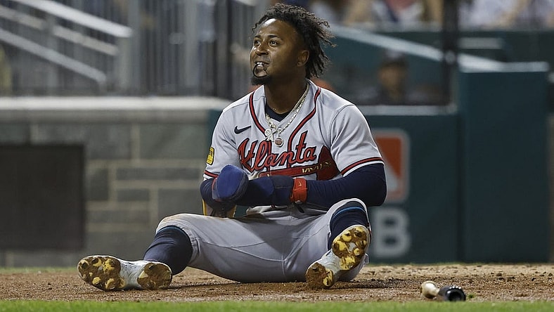 Sep 21, 2023; Washington, District of Columbia, USA; Atlanta Braves second baseman Ozzie Albies (1) sits at home plate after scoring a run on a single by Braves third baseman Austin Riley (not pictured) against the Washington Nationals during the third inning at Nationals Park. Mandatory Credit: Geoff Burke-USA TODAY Sports