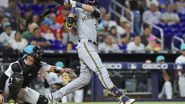 Sep 22, 2023; Miami, Florida, USA; Milwaukee Brewers left fielder Christian Yelich (22) hits a solo home run against the Miami Marlins during the second inning at loanDepot Park. Mandatory Credit: Sam Navarro-USA TODAY Sports