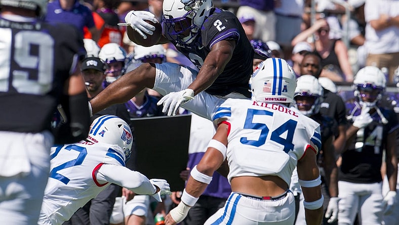 Sep 23, 2023; Fort Worth, Texas, USA; TCU Horned Frogs running back Trey Sanders (2) attempts to leap over SMU Mustangs safety Cale Sanders Jr. (22) during the first half at Amon G. Carter Stadium. Mandatory Credit: Jerome Miron-USA TODAY Sports