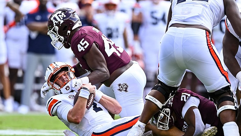 Sep 23, 2023; College Station, Texas, USA; Texas A&M Aggies linebacker Edgerrin Cooper (45) sacks Auburn Tigers quarterback Payton Thorne (1) during the first half at Kyle Field. Mandatory Credit: Maria Lysaker-USA TODAY Sports