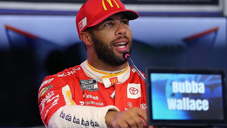 Sep 23, 2023; Fort Worth, Texas, USA; NASCAR Cup driver Bubba Wallace (23) addresses the media after winning the pole for the Auto Trader EchoPark Automotive 400 at Texas Motor Speedway. Mandatory Credit: Michael C. Johnson-USA TODAY Sports