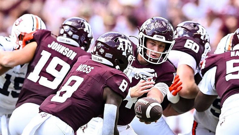 Sep 23, 2023; College Station, Texas, USA; Texas A&M Aggies quarterback Max Johnson (14) hands off the ball to running back Le'Veon Moss (8) during the third quarter against the Auburn Tigers at Kyle Field. Mandatory Credit: Maria Lysaker-USA TODAY Sports