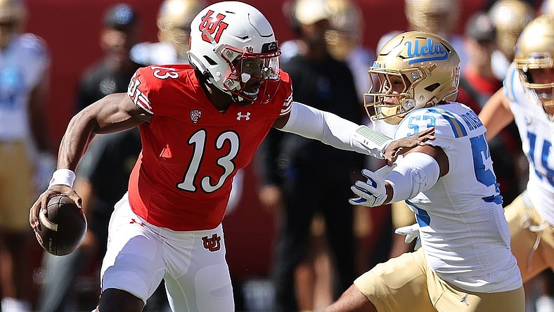 Sep 23, 2023; Salt Lake City, Utah, USA; Utah Utes quarterback Nate Johnson (13) is chased by UCLA Bruins linebacker Darius Muasau (53) in the first quarter at Rice-Eccles Stadium. Mandatory Credit: Rob Gray-USA TODAY Sports