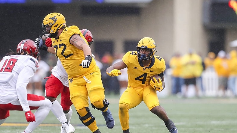 Sep 23, 2023; Morgantown, West Virginia, USA; West Virginia Mountaineers running back CJ Donaldson Jr. (4) runs the ball during the first quarter against the Texas Tech Red Raiders at Mountaineer Field at Milan Puskar Stadium. Mandatory Credit: Ben Queen-USA TODAY Sports