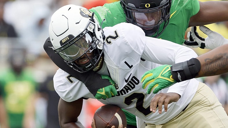 Sep 23, 2023; Eugene, Oregon, USA; Oregon Ducks defensive end Jordan Burch (1) sacks Colorado Buffaloes quarterback Shedeur Sanders (2) during the first half at Autzen Stadium. Mandatory Credit: Soobum Im-USA TODAY Sports