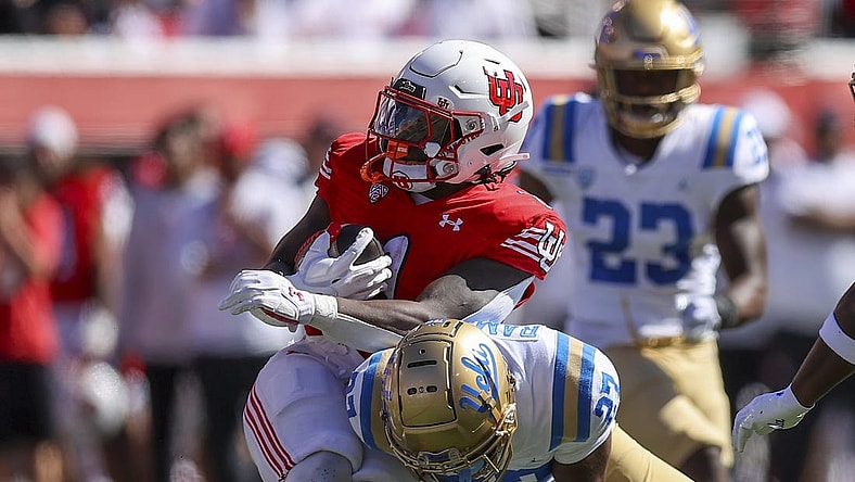 Sep 23, 2023; Salt Lake City, Utah, USA; UCLA Bruins defensive back Kamari Ramsey (27) tackles Utah Utes running back Jaylon Glover (1) in the second quarter at Rice-Eccles Stadium. Mandatory Credit: Rob Gray-USA TODAY Sports
