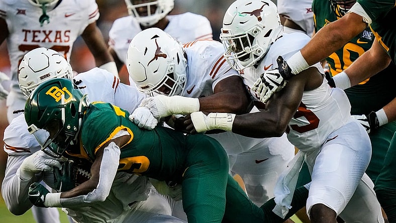 The Texas Longhorns defense stop DUPLICATE***Baylor running back Richard Reese (29) from advancing in the first quarter of the game, Saturday, Sept. 23 at McLane Stadium in Waco.