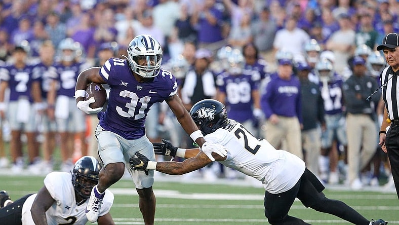 Sep 23, 2023; Manhattan, Kansas, USA; UCF Knights defensive back Nikai Martinez (21) misses a tackle on Kansas State Wildcats running back DJ Giddens (31) during the first quarter at Bill Snyder Family Football Stadium. Mandatory Credit: Scott Sewell-USA TODAY Sports