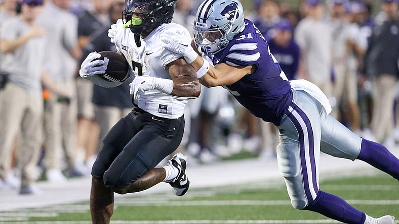 Sep 23, 2023; Manhattan, Kansas, USA; Kansas State Wildcats linebacker Jake Clifton (31) tries to tackle UCF Knights running back RJ Harvey (7) during the first quarter at Bill Snyder Family Football Stadium. Mandatory Credit: Scott Sewell-USA TODAY Sports