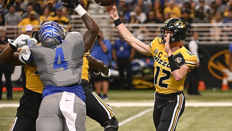 Sep 23, 2023; St. Louis, Missouri, USA; Memphis Tigers defensive lineman Josh Ellison (4) attempts to block a pass from Missouri Tigers quarterback Brady Cook (12) in the first quarter at The Dome at America's Center. Mandatory Credit: Joe Puetz-USA TODAY Sports