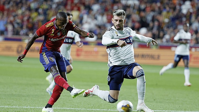 Sep 23, 2023; Sandy, Utah, USA; Real Salt Lake forward Carlos Andres Gomez (11) gets off a shot against Vancouver Whitecaps defender Tristan Blackmon (6) in the first half at America First Field. Mandatory Credit: Jeff Swinger-USA TODAY Sports