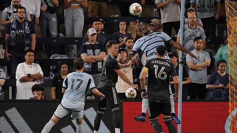 Sep 23, 2023; Kansas City, Kansas, USA; Sporting Kansas City defender Dany Rosero (5) and Houston Dynamo forward Corey Baird (11) go up for a header during the second half at Children's Mercy Park. Mandatory Credit: Denny Medley-USA TODAY Sports