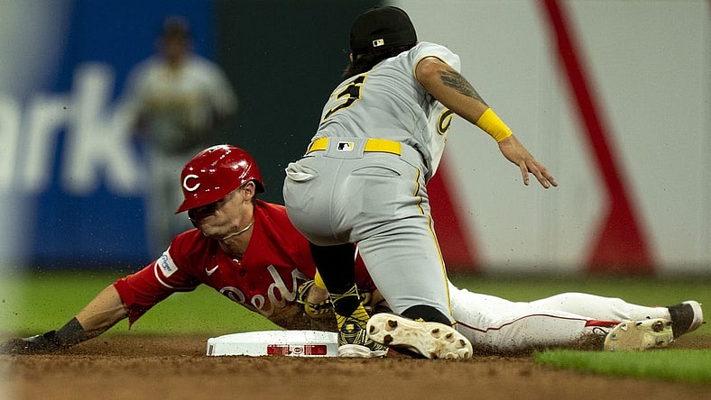 Sep 23, 2023; Cincinnati, Ohio, USA;  Cincinnati Reds center fielder TJ Friedl (29) steals second as Pittsburgh Pirates second baseman Ji Hwan Bae (3) attempts to tag him in the seventh inning at Great American Ball Park. Mandatory Credit: The Cincinnati Enquirer-USA TODAY Sports