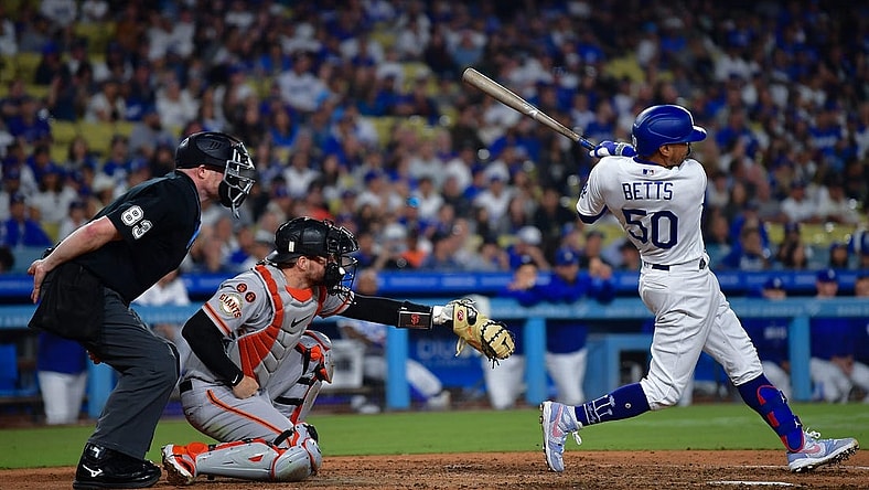 Sep 23, 2023; Los Angeles, California, USA; Los Angeles Dodgers second baseman Mookie Betts (50) hits a two run RBI double against the San Francisco Giants during the eighth inning at Dodger Stadium. Mandatory Credit: Gary A. Vasquez-USA TODAY Sports