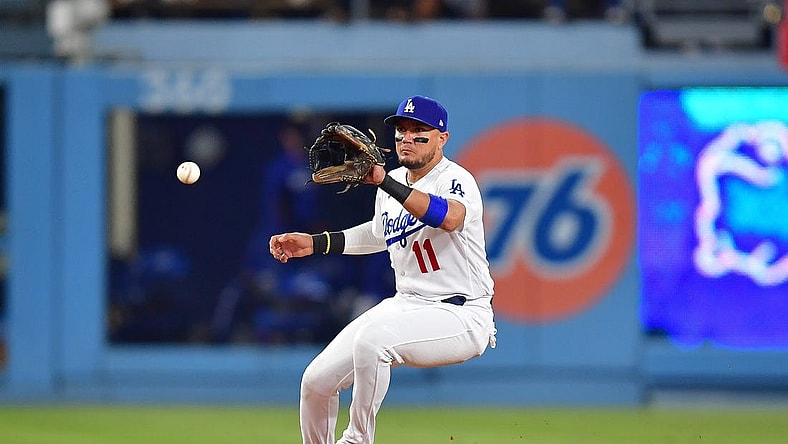 Sep 23, 2023; Los Angeles, California, USA; Los Angeles Dodgers shortstop Miguel Rojas (11) fields the ground ball of San Francisco Giants third baseman J.D. Davis (7) during the ninth inning at Dodger Stadium. Mandatory Credit: Gary A. Vasquez-USA TODAY Sports