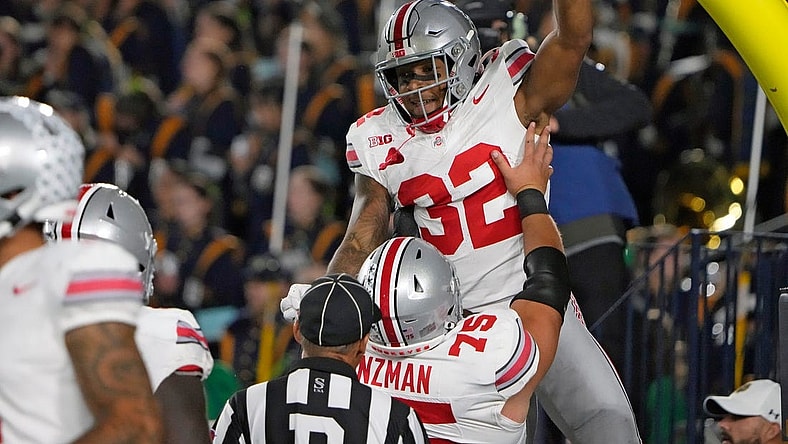 Sep 23, 2023; South Bend, Indiana, USA; Ohio State Buckeyes running back TreVeyon Henderson (32) celebrates his rushing touchdown with Ohio State Buckeyes offensive lineman Carson Hinzman (75) during the third quarter of their game against Notre Dame Fighting Irish at Notre Dame Stadium.