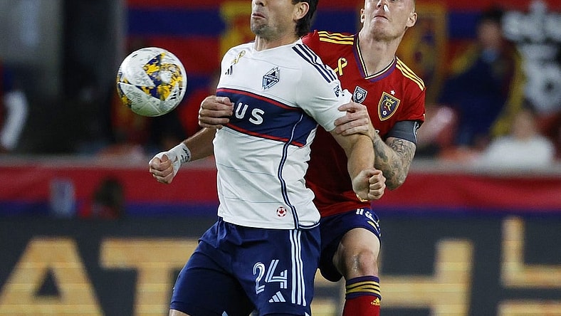 Sep 23, 2023; Sandy, Utah, USA; Vancouver Whitecaps forward Brian White (24) and Real Salt Lake defender Justen Glad (15) battle in the second half at America First Field. Mandatory Credit: Jeff Swinger-USA TODAY Sports