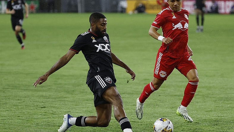 Sep 23, 2023; Washington, District of Columbia, USA; D.C. United defender Ruan (2) passes the ball as New York Red Bulls midfielder Omir Fernandez (21) chases in the first half at Audi Field. Mandatory Credit: Geoff Burke-USA TODAY Sports