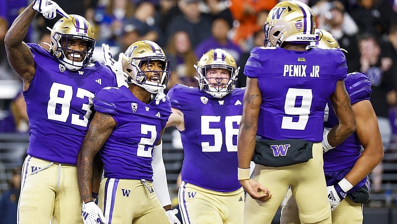 Sep 23, 2023; Seattle, Washington, USA; Washington Huskies wide receiver JaLynn Polk (2) celebrates with tight end Devin Culp (83), offensive lineman Geirean Hatchett (56) and quarterback Michael Penix Jr. (9) after catching a touchdown pass against the California Golden Bears during the second quarter at Alaska Airlines Field at Husky Stadium. Mandatory Credit: Joe Nicholson-USA TODAY Sports