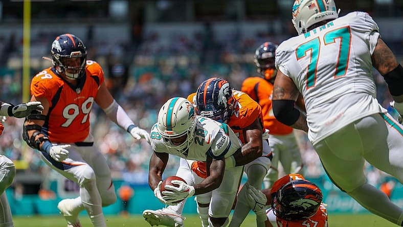 Sep 24, 2023; Miami Gardens, Florida, USA;  Miami Dolphins running back De'Von Achane (28) scores a touchdown  against the Denver Broncos in the first quarter at Hard Rock Stadium. Mandatory Credit: Nathan Ray Seebeck-USA TODAY Sports