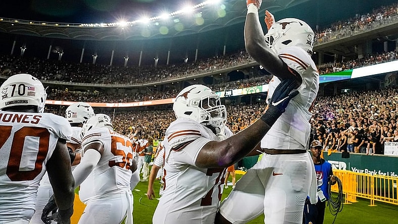 Texas offensive lineman Kelvin Banks Jr. (78) and Texas running back CJ Baxter (4) celebrate a touchdown against Baylor in the second half of an NCAA college football game, Saturday, Sept. 23, 2023, in Waco, Texas.