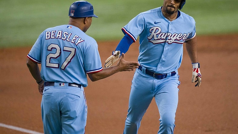 Sep 24, 2023; Arlington, Texas, USA; Texas Rangers second baseman Marcus Semien (2) rounds the bases past third base coach Tony Beasley (27) after Semien hits a lead off home run against the Seattle Mariners during the first inning at Globe Life Field. Mandatory Credit: Jerome Miron-USA TODAY Sports