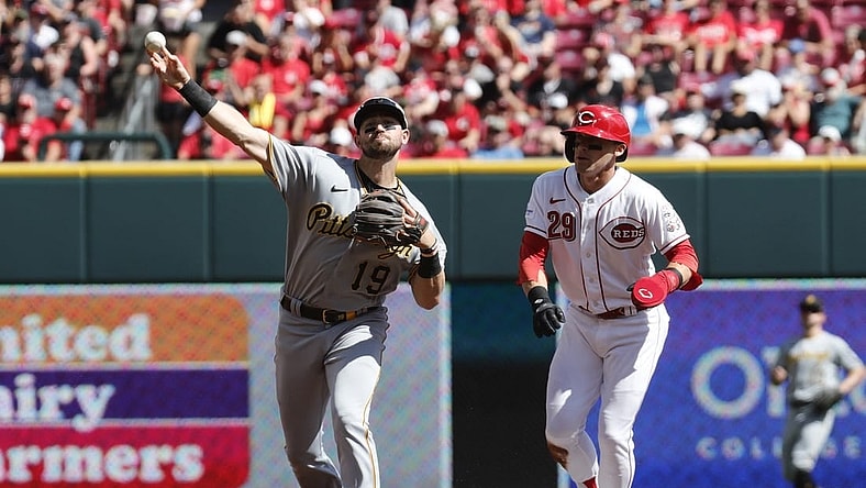 Sep 24, 2023; Cincinnati, Ohio, USA; Cincinnati Reds center fielder TJ Friedl (29) is forced out at second as Pittsburgh Pirates second baseman Jared Triolo (19) throws to first during the first inning at Great American Ball Park. Mandatory Credit: David Kohl-USA TODAY Sports