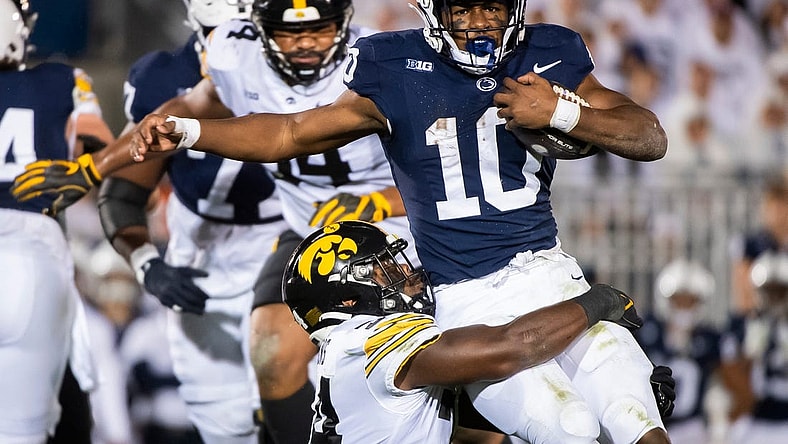 Iowa linebacker Jay Higgins tackles Penn State running back Nick Singleton near the line of scrimmage during the White Out game at Beaver Stadium Saturday, Sept. 23, 2023, in State College, Pa.