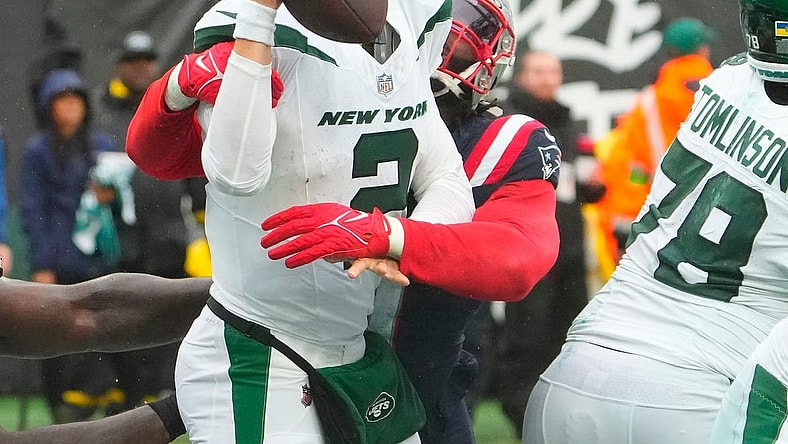 Sep 24, 2023; East Rutherford, New Jersey, USA; New York Jets quarterback Zach Wilson (2) is sacked for a safety by New England Patriots linebacker Matthew Judon (9) in the 4th quarter at MetLife Stadium. Mandatory Credit: Robert Deutsch-USA TODAY Sports