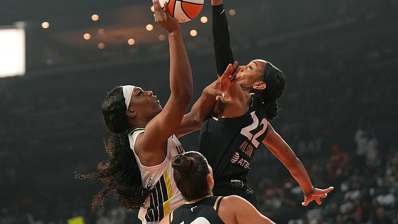 Sep 24, 2023; Las Vegas, Nevada, USA; Las Vegas Aces center A'ja Wilson (22) blocks a jump shot by Dallas Wings center Teaira McCowan (7) during the first half of game one of the 2023 WNBA Playoffs at Michelob Ultra Arena. Mandatory Credit: Kirby Lee-USA TODAY Sports