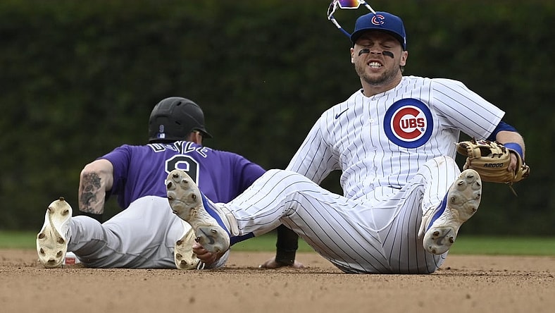 Sep 24, 2023; Chicago, Illinois, USA;   Chicago Cubs second baseman Nico Hoerner (2) after tagging Colorado Rockies center fielder Brenton Doyle (9) out on an attempted steal during the eighth inning at Wrigley Field. Mandatory Credit: Matt Marton-USA TODAY Sports