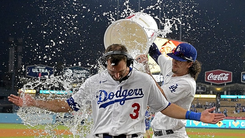 Sep 24, 2023; Los Angeles, California, USA; Los Angeles Dodgers center fielder James Outman (33) dumps a bucket of ice water on shortstop Chris Taylor (3) after he hit a walk-off RBI single to defeat the San Francisco Giants in the tenth inning at Dodger Stadium. Mandatory Credit: Jayne Kamin-Oncea-USA TODAY Sports